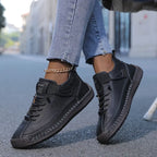Women's ankle-height lace-up sneakers with contrast stitching and a flat ridged sole