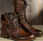 Ankle-height lace-up combat boots with round toes and treaded soles