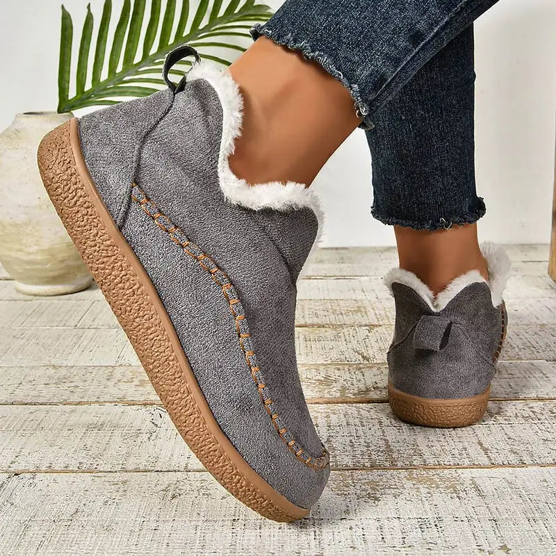 Women's low-cut ankle boots with light trim, stitched detailing and textured flat soles