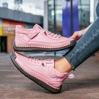 Women's ankle-height lace-up sneakers with contrast stitching and a flat ridged sole